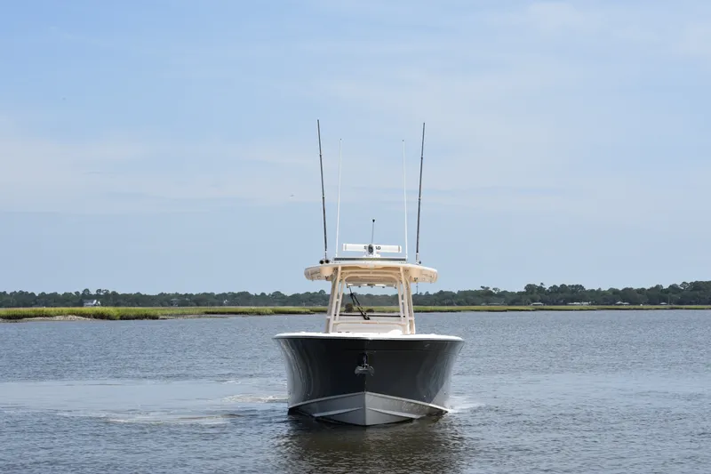Slide: The Image of 2019 Grady-White Canyon 336 boat cruising on calm waters under a clear sky. - 10