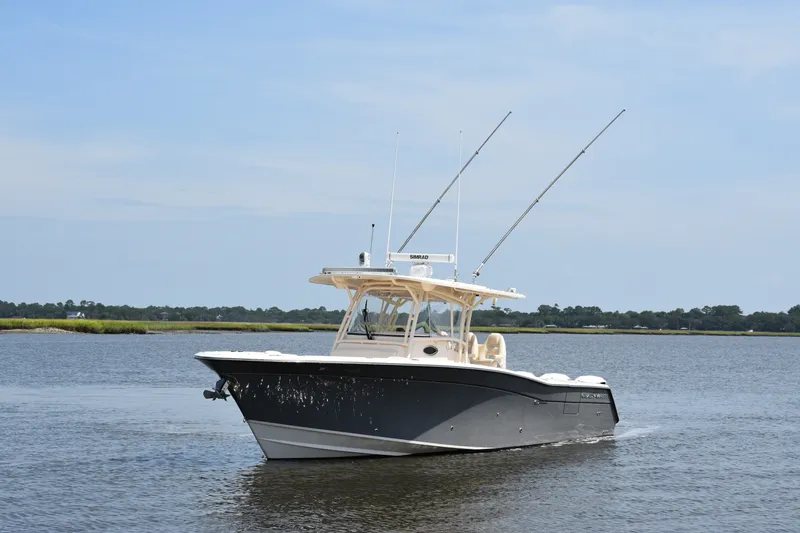 Slide: The Image of 2019 Grady-White Canyon 336 boat on calm water, featuring dual antennas. - 11