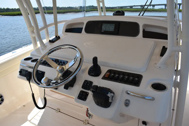 Slide: The Image of 2019 Grady-White Canyon 336 helm with steering wheel and control panel by the water. - 30