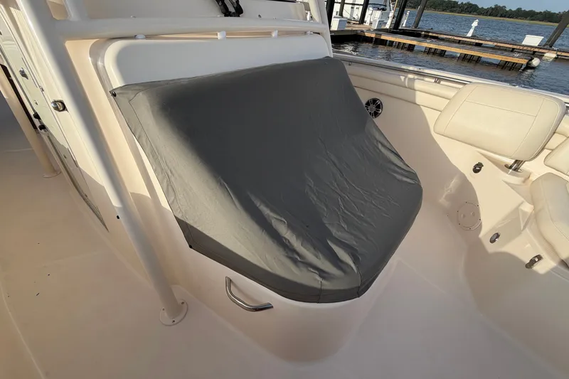 Slide: The Image of 2019 Grady-White Canyon 336 boat interior with covered seating area by the dock. - 53