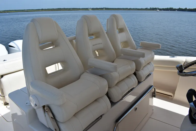 Slide: The Image of Luxury seating on 2019 Grady-White Canyon 336 boat, overlooking serene water. - 31