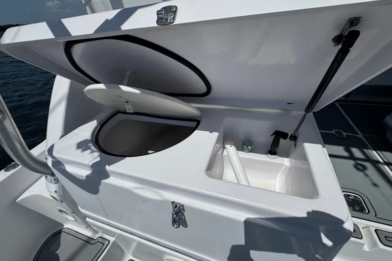 Slide: The Image of Open storage compartment on a 2003 PROLINE 33 Express boat, featuring a sink and faucet. - 22