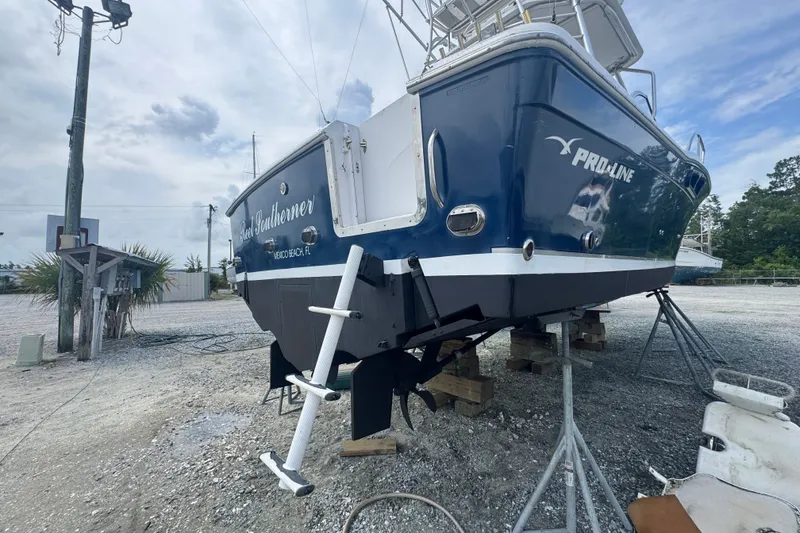 Slide: The Image of 2003 PROLINE 33 Express boat on dry dock, blue hull, Mexico Beach, FL. - 36