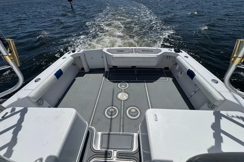 Slide: The Image of 2003 PROLINE 33 Express boat deck with ocean view and wake trail. - 16
