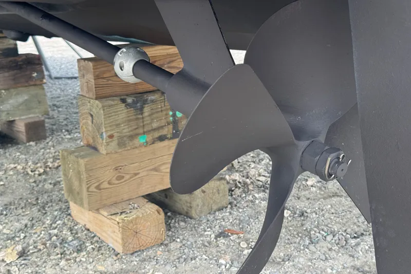 Slide: The Image of Propeller of 2003 PROLINE 33 Express boat on wooden blocks, close-up view. - 45