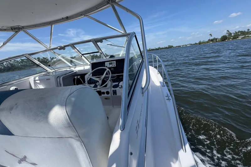Slide: The Image of 2003 PROLINE 33 Express boat cruising on a sunny day, with clear blue skies. - 9