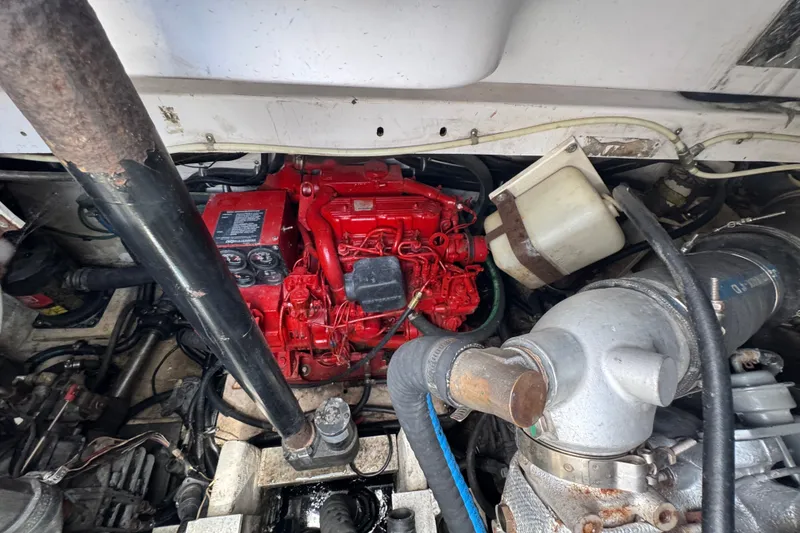 Slide: The Image of Engine compartment of a 2003 PROLINE 33 Express boat, featuring a red engine. - 34