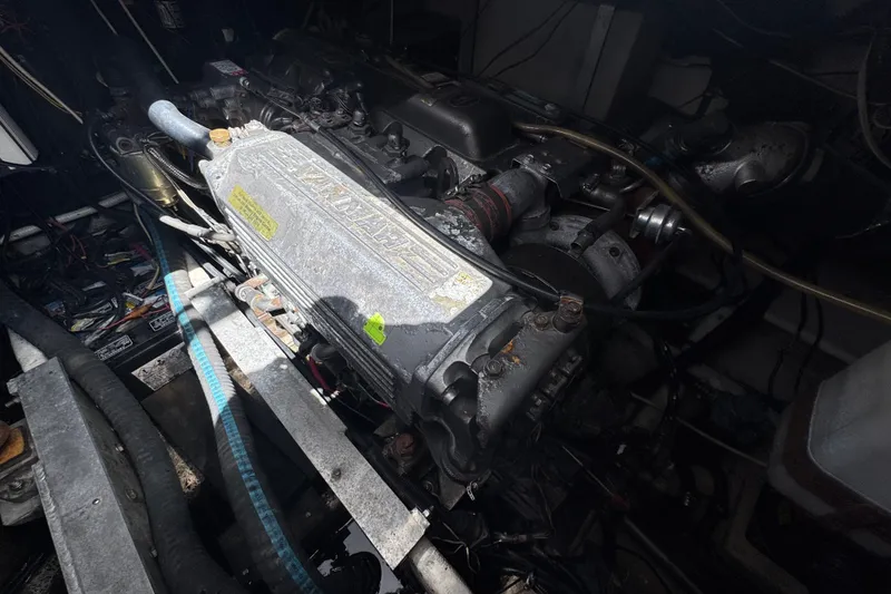 Slide: The Image of Engine compartment of a 2003 PROLINE 33 Express boat, showcasing mechanical components and wiring. - 33