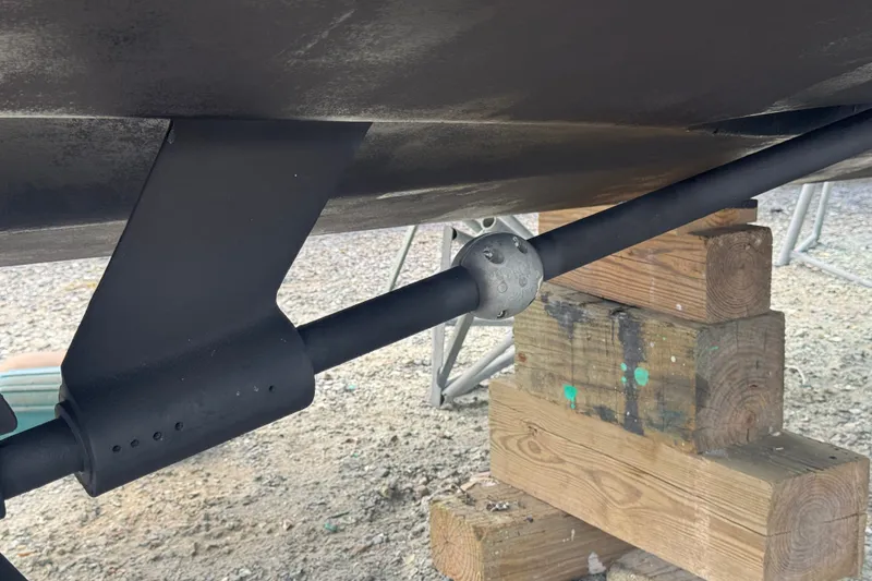 Slide: The Image of 2003 PROLINE 33 Express boat underside with propeller shaft and zinc anode on wooden blocks. - 38