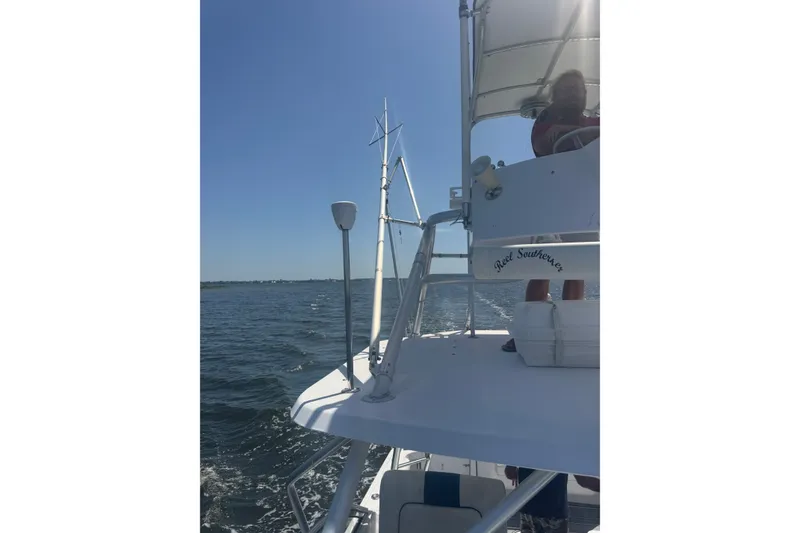 Slide: The Image of 2003 PROLINE 33 Express boat cruising on open water under clear blue sky. - 14
