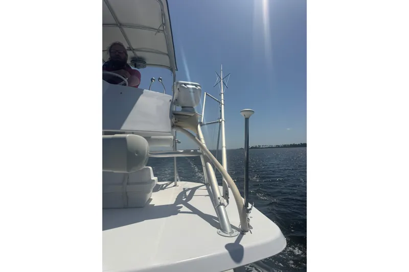 Slide: The Image of 2003 PROLINE 33 Express boat cruising on a sunny day, with clear blue skies and calm waters. - 13