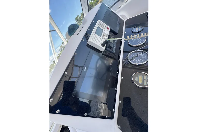Slide: The Image of Control panel of 2003 PROLINE 33 Express boat with gauges and radio equipment. - 29