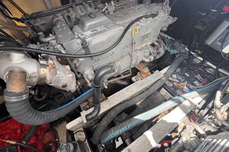 Slide: The Image of Engine compartment of a 2003 PROLINE 33 Express boat, showcasing mechanical components and wiring. - 32