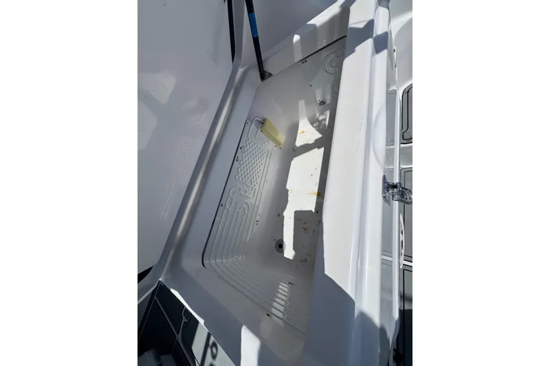 Slide: The Image of Open storage compartment on a 2003 PROLINE 33 Express boat, showcasing interior details. - 21