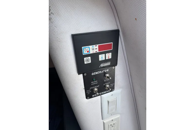 Slide: The Image of Control panel of a 2003 PROLINE 33 Express boat, featuring generator and air system controls. - 31