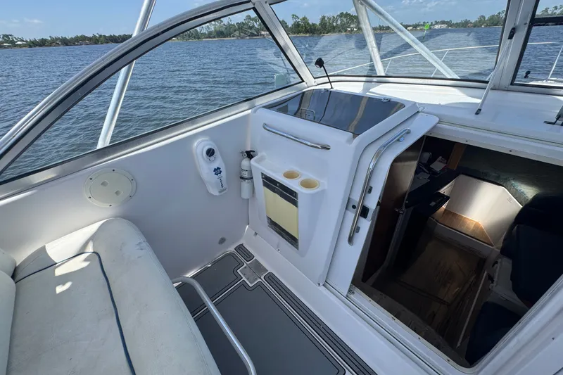 Slide: The Image of 2003 PROLINE 33 Express boat interior with cabin entrance, seating, and water view. - 25