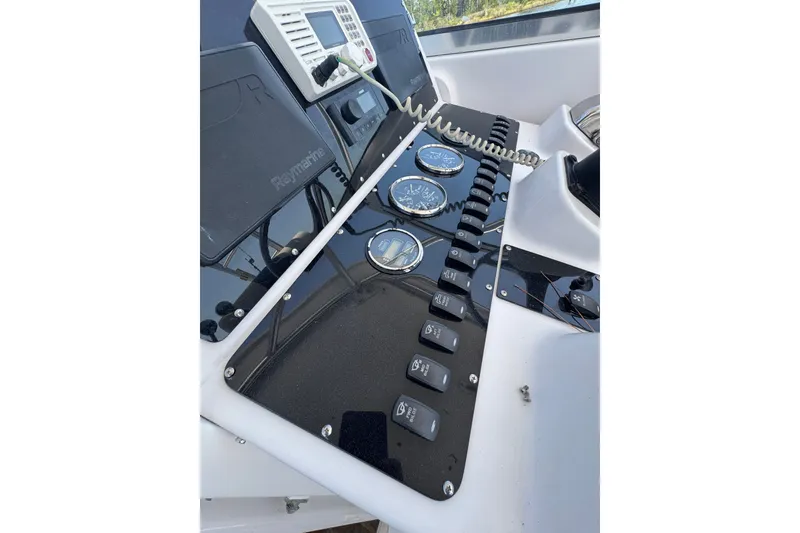Slide: The Image of Control panel of 2003 PROLINE 33 Express boat with gauges and switches. - 28