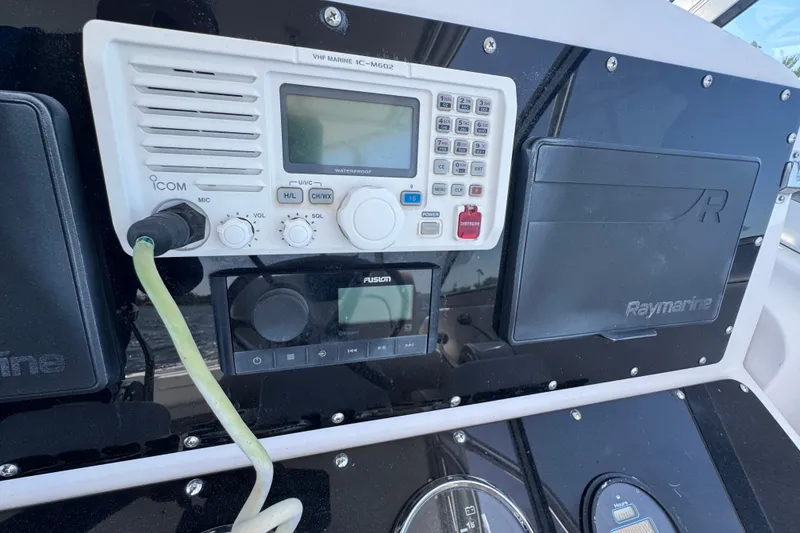 Slide: The Image of Control panel of a 2003 PROLINE 33 Express boat with Icom and Raymarine equipment. - 30