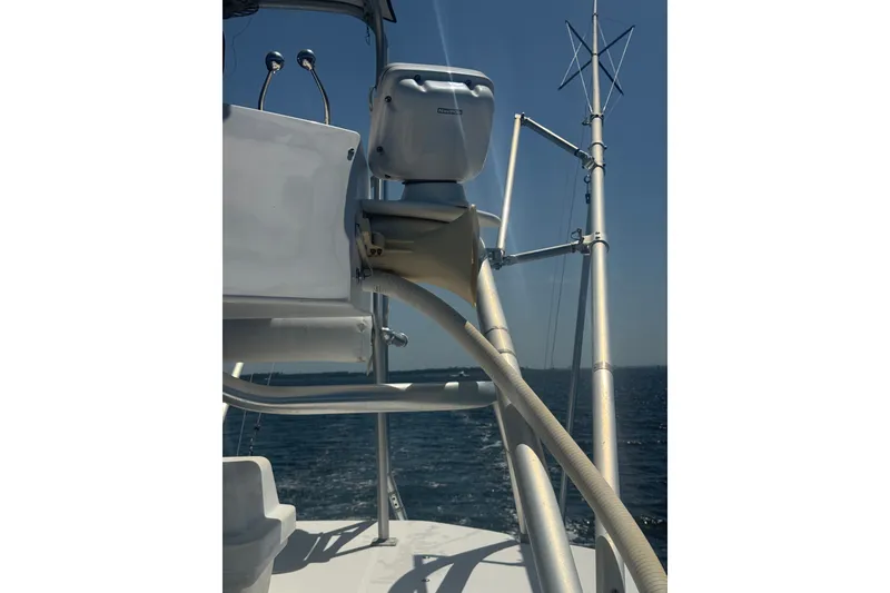 Slide: The Image of 2003 PROLINE 33 Express boat with radar and antenna, sailing on open water. - 12