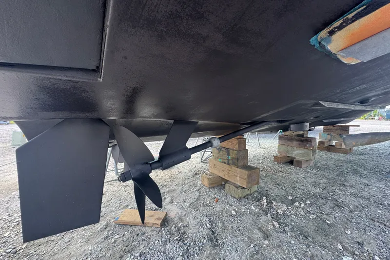 Slide: The Image of 2003 PROLINE 33 Express boat underside with propeller and rudder on wooden blocks. - 37