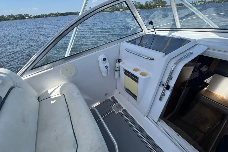 Slide: The Image of 2003 PROLINE 33 Express boat interior with seating, storage, and water view. - 24