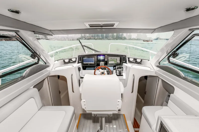 Slide: The Image of Interior view of 2021 ArrowCat 320 boat cockpit with modern navigation equipment. - 21