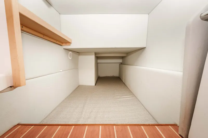 Slide: The Image of Interior cabin space of 2021 ArrowCat 320 boat, featuring minimalist design and wooden flooring. - 27