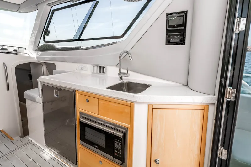 Slide: The Image of Modern galley kitchen in 2021 ArrowCat 320 boat with sink, microwave, and storage. - 18