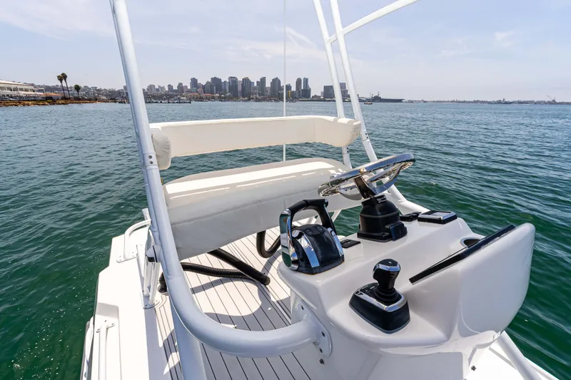 Slide: The Image of Cockpit view of 2021 ArrowCat 320 boat with city skyline in background. - 15