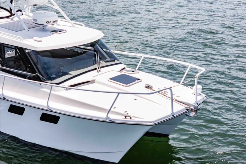 Slide: The Image of 2021 ArrowCat 320 boat on water, featuring sleek design and advanced navigation equipment. - 10