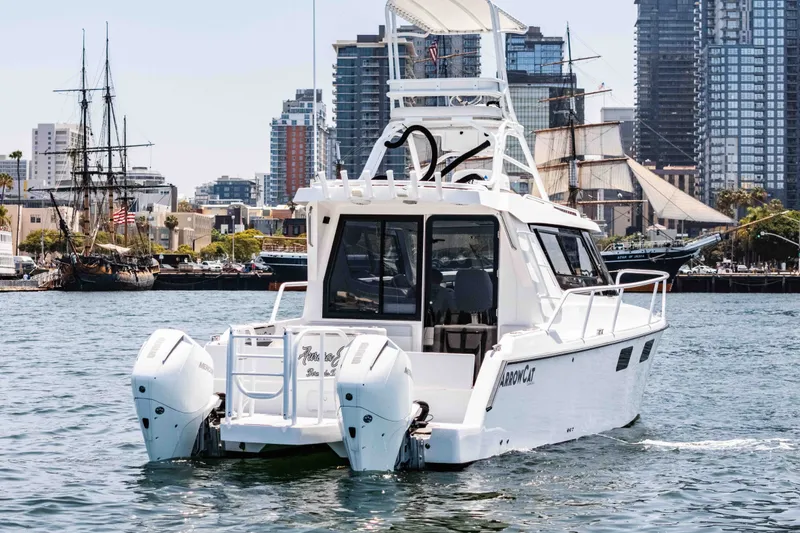 Slide: The Image of 2021 ArrowCat 320 boat cruising in urban harbor with city skyline backdrop. - 8