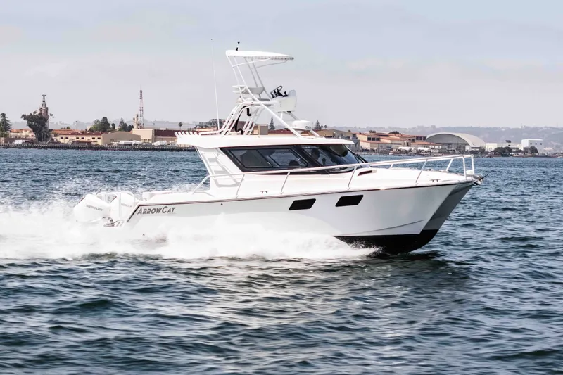 The Image of 2021 ArrowCat 320 boat cruising on water near coastal buildings. - 0