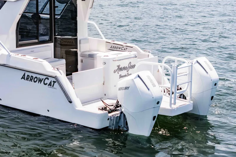 Slide: The Image of 2021 ArrowCat 320 boat with dual Mercury engines on water. - 9