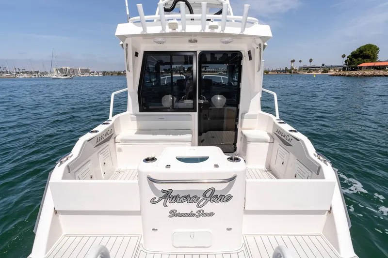 Slide: The Image of ArrowCat 320 boat, 2021 model, docked on calm waters with clear skies. - 11