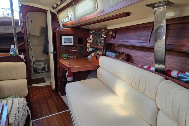 Slide: The Image of Interior of a 1990 Pearson 385 sailboat with cozy seating and navigation area. - 12