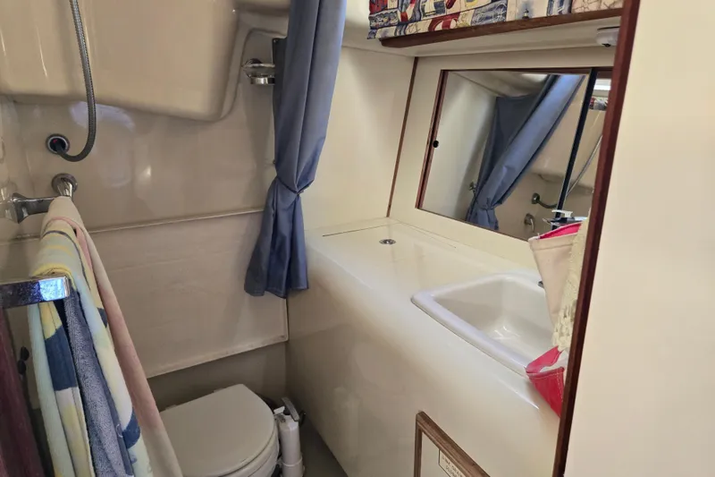 Slide: The Image of Bathroom interior of a 1990 Pearson 385 yacht, featuring sink, toilet, and shower. - 20