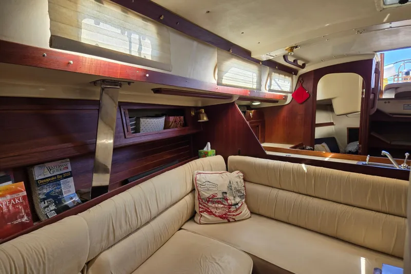 Slide: The Image of Interior of a 1990 Pearson 385 sailboat with beige seating and wooden accents. - 10