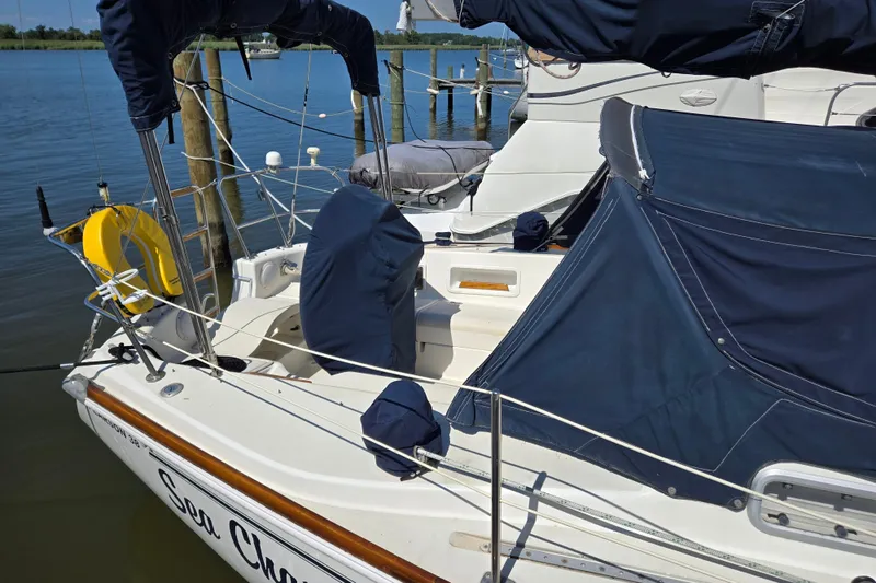 Slide: The Image of Sailboat docked at marina, Pearson 385 model, 1990, with blue covers and life preserver. - 3