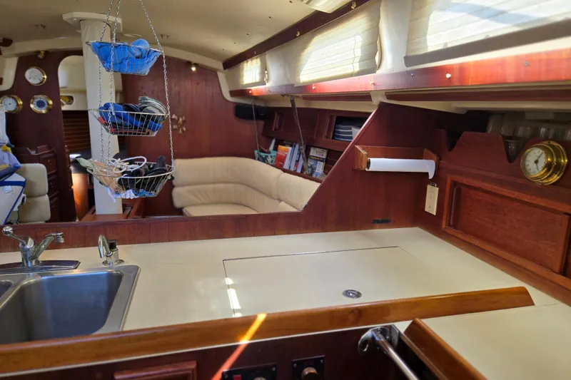Slide: The Image of Interior of a 1990 Pearson 385 sailboat with kitchen and cozy seating area. - 16