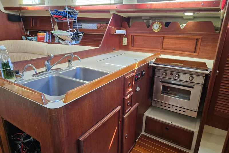Slide: The Image of Interior of a 1990 Pearson 385 sailboat galley with wood finish and stainless steel appliances. - 15