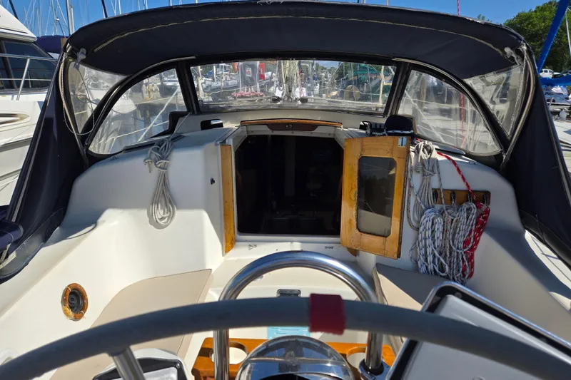 Slide: The Image of Cockpit of a 1990 Pearson 385 sailboat with ropes and steering wheel. - 6