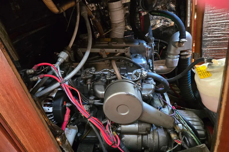 Slide: The Image of Engine compartment of a 1990 Pearson 385 sailboat, showing detailed mechanical components. - 24