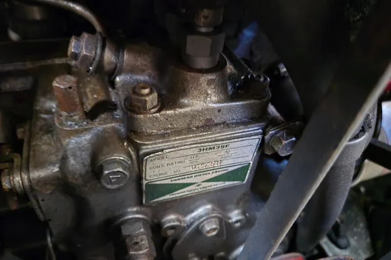Slide: The Image of Close-up of a 1990 Pearson 385 engine component with visible model and engine number. - 23