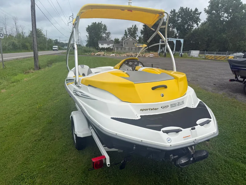 Slide: The Image of A 2006 Sea-Doo Sportster SCIC with yellow and white design sits on a trailer on grass. - 4