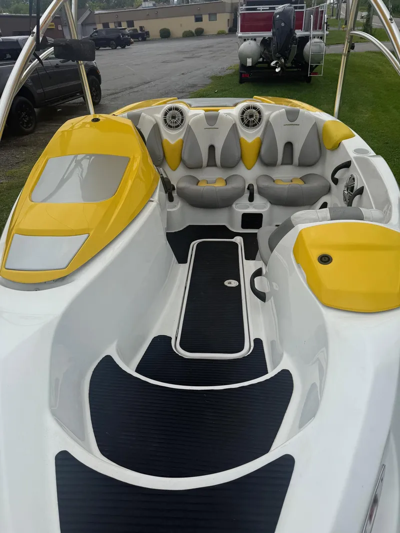 Slide: The Image of A 2006 Sea-Doo Sportster SCIC with yellow and gray seating. It features a modern design. - 5