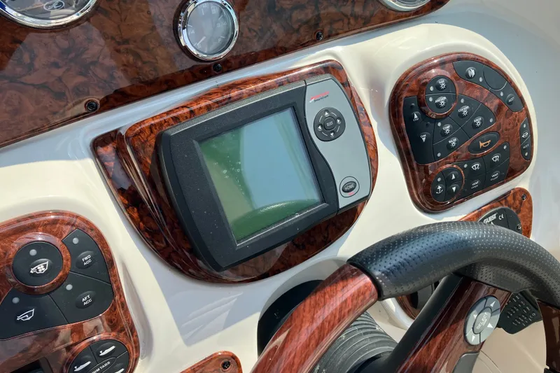 Slide: The Image of Dashboard of a 2006 Sea Ray 290 Sun Sport boat with navigation controls. - 9