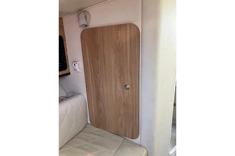 Slide: The Image of Interior cabin door of 2006 Sea Ray 290 Sun Sport boat, featuring wood finish and modern design. - 25