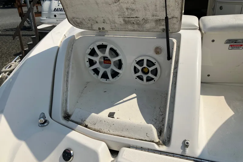 Slide: The Image of 2006 Sea Ray 290 Sun Sport boat with open storage compartment and speakers. - 12