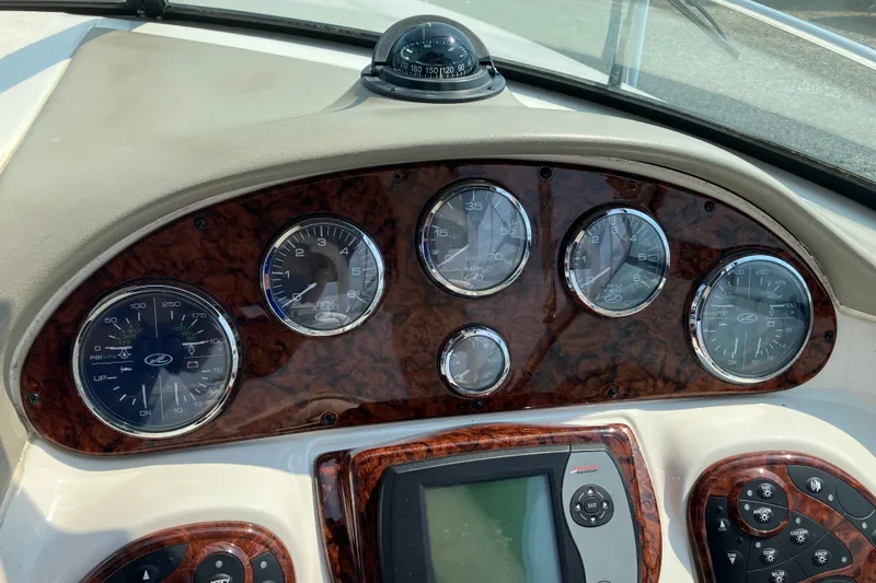 Slide: The Image of Dashboard of 2006 Sea Ray 290 Sun Sport boat with gauges and controls. - 8