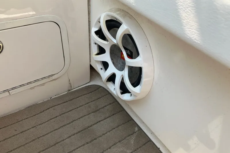 Slide: The Image of Speaker on 2006 Sea Ray 290 Sun Sport boat, featuring white panel and carpeted floor. - 11